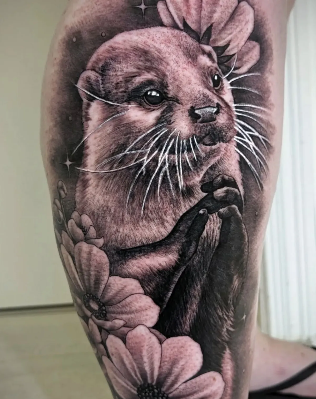 Realistic otter portrait tattoo with detailed water elements